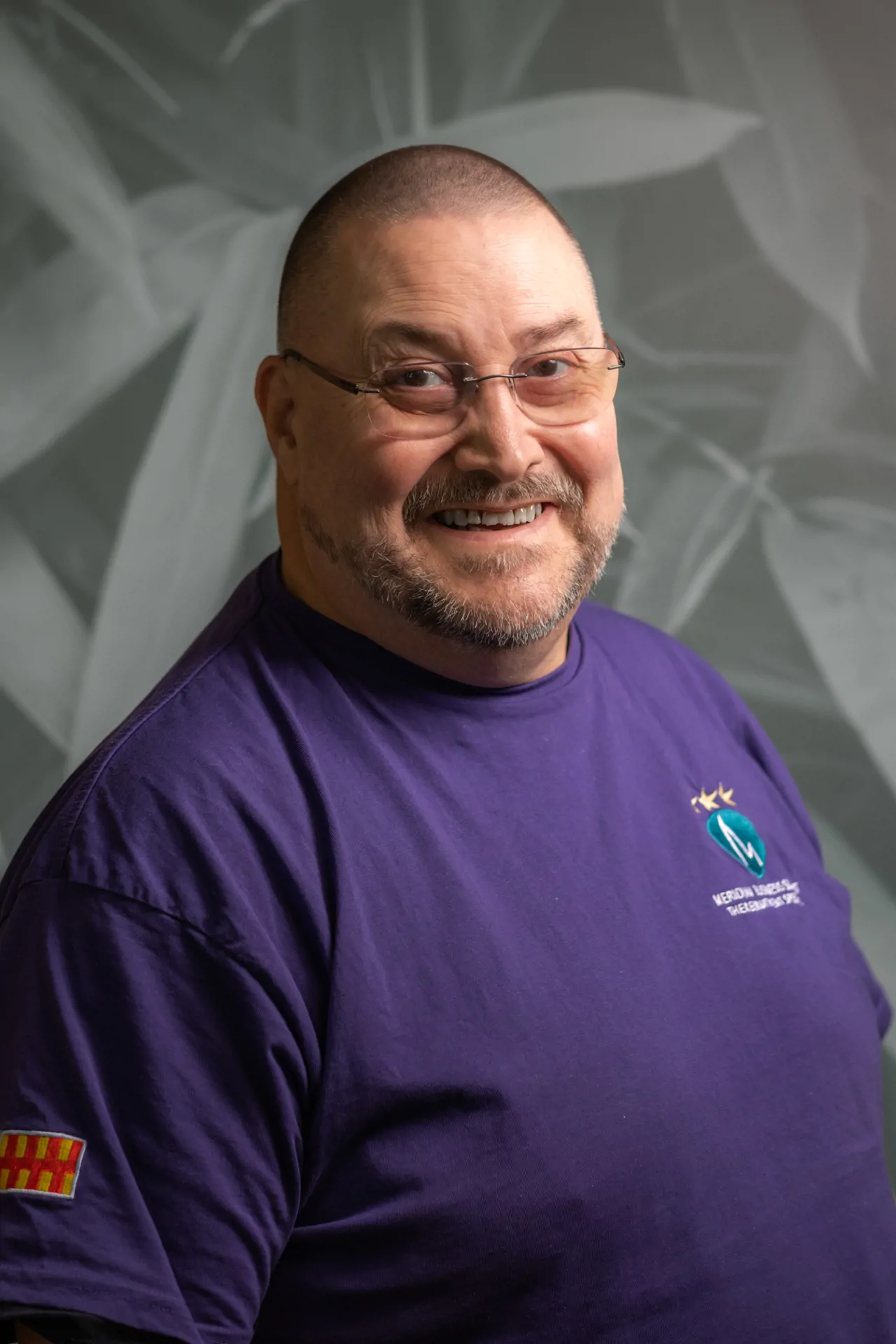 CEO headshot photo in purple Meridian branded jumper