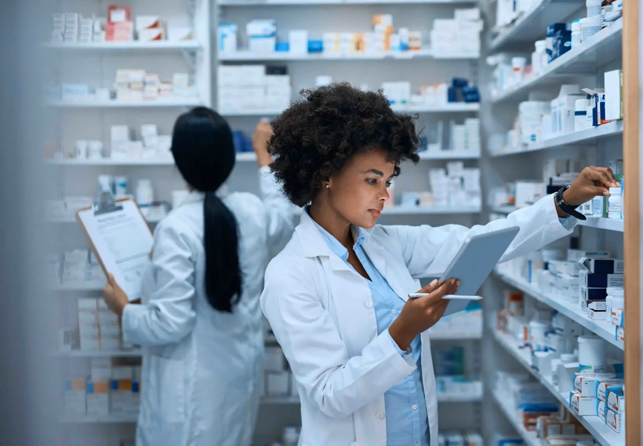 Two female pharmacists checking stock 