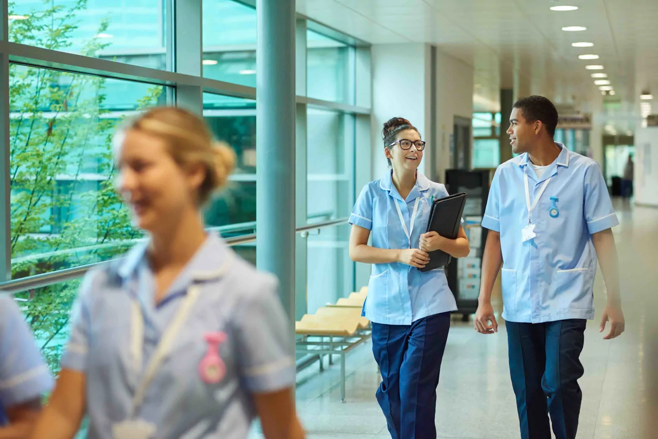 Two Healthcare professionals walking down a hospital corridor